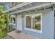 Exterior front view of the home with an entrance door, gray concrete, and plants at 10208 N 23Rd St, Tampa, FL 33612
