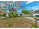 Quaint home featuring a well-kept lawn, mature tree, mailbox, and a driveway at 10208 N 23Rd St, Tampa, FL 33612