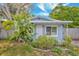 Charming home with a blue exterior, nice lawn, plants, and lovely landscaping at 10208 N 23Rd St, Tampa, FL 33612