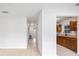 Bright hallway leading to the kitchen with wood cabinets at 10208 N 23Rd St, Tampa, FL 33612
