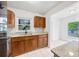 Cozy kitchen featuring wooden cabinets, granite countertops, and plenty of natural light at 10208 N 23Rd St, Tampa, FL 33612