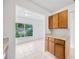 Compact kitchen with wooden cabinets and granite countertops open to living area at 10208 N 23Rd St, Tampa, FL 33612