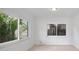 Living room featuring two large windows offering lots of natural light at 10208 N 23Rd St, Tampa, FL 33612