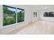Bright, spacious living room with tile floors and large windows at 10208 N 23Rd St, Tampa, FL 33612