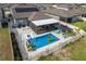 Aerial view showcasing a pool, screen enclosed patio, outdoor gazebo, and solar panels on the roof at 10313 Wine Press Ave, Riverview, FL 33578