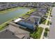 Aerial view of the backyard, including a lake view, pool, and screened-in patio at 10313 Wine Press Ave, Riverview, FL 33578