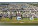 Aerial view showing location on the lake and the fenced in backyard with pool and solar panels at 10313 Wine Press Ave, Riverview, FL 33578