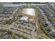 A high up aerial view shows the community's amenities including pool, clubhouse, and tennis courts at 10313 Wine Press Ave, Riverview, FL 33578