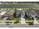 An aerial view of a two-story home with a backyard pool, lush landscaping, and a tranquil lake view at 10313 Wine Press Ave, Riverview, FL 33578
