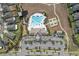 Aerial view of the community clubhouse, pool, tennis courts, parking, and a play ground at 10313 Wine Press Ave, Riverview, FL 33578