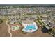Aerial view showcasing the community clubhouse, swimming pool, tennis courts, and ample parking at 10313 Wine Press Ave, Riverview, FL 33578