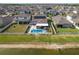 Backyard aerial view of pool, screened lanai, outdoor gazebo, and solar panels on the roof at 10313 Wine Press Ave, Riverview, FL 33578