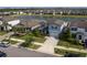 Scenic view of a blue home near a lake, surrounded by manicured lawns at 10313 Wine Press Ave, Riverview, FL 33578