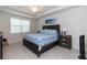 Relaxing bedroom features a comfortable bed, ceiling fan, and serene beach artwork, creating a peaceful retreat at 10313 Wine Press Ave, Riverview, FL 33578