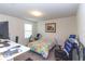 Cozy bedroom with a bed, desk, artwork, and a window for natural light at 10313 Wine Press Ave, Riverview, FL 33578