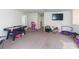 Large bonus room with carpet flooring, TV, games and plenty of space for recreation at 10313 Wine Press Ave, Riverview, FL 33578