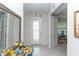 Bright foyer with tile flooring and a decorative front door at 10313 Wine Press Ave, Riverview, FL 33578