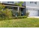 Charming home exterior with lush landscaping and a well-maintained lawn at 10313 Wine Press Ave, Riverview, FL 33578