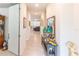 Bright hallway leading to the living area, adorned with decorative accents and neutral colors at 10313 Wine Press Ave, Riverview, FL 33578