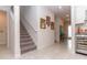 Inviting hallway with staircase and tile floors; seamlessly connects living spaces at 10313 Wine Press Ave, Riverview, FL 33578