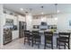 Stylish kitchen with granite countertops, pendant lighting, stainless steel appliances, and island seating at 10313 Wine Press Ave, Riverview, FL 33578