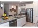 Open concept kitchen features a large island, stainless steel appliances, white cabinets, and granite countertops at 10313 Wine Press Ave, Riverview, FL 33578