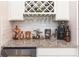 Elegant kitchen with white cabinets, granite countertops, wine rack and unique copper decor at 10313 Wine Press Ave, Riverview, FL 33578