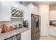 Bright kitchen features white cabinetry, granite countertops, wine rack, subway tile backsplash, and stainless-steel appliances at 10313 Wine Press Ave, Riverview, FL 33578