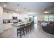 Open-concept kitchen with island seating flows seamlessly into the living and dining areas at 10313 Wine Press Ave, Riverview, FL 33578