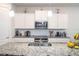 Well-equipped kitchen with granite countertops, stainless steel appliances, and modern fixtures at 10313 Wine Press Ave, Riverview, FL 33578