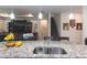 Open-concept kitchen and living area with granite countertops and an island with sink, perfect for entertaining at 10313 Wine Press Ave, Riverview, FL 33578