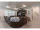 Cozy living room featuring a large leather sectional, ceiling fan, and custom entertainment center at 10313 Wine Press Ave, Riverview, FL 33578