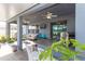 Covered patio with an outdoor kitchen, bar seating, a TV and comfortable seating at 10313 Wine Press Ave, Riverview, FL 33578