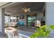 The covered patio features an outdoor kitchen, seating, and a ceiling fan at 10313 Wine Press Ave, Riverview, FL 33578