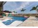 Backyard pool with in-pool seating, gazebo, and lush landscaping at 10313 Wine Press Ave, Riverview, FL 33578