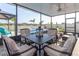 Inviting screened patio with comfortable seating and a view of the backyard pool at 10313 Wine Press Ave, Riverview, FL 33578