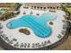 Aerial view showcasing the community's clover-shaped pool with lap lanes and sunbathing areas at 10313 Wine Press Ave, Riverview, FL 33578