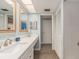 Beautiful updated bathroom with white cabinets, quartz countertops, and coastal-themed decor at 105 Woodlake Wynde, Oldsmar, FL 34677