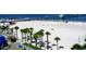 Picturesque beach with palm trees, white sand, and a pier in the background at 105 Woodlake Wynde, Oldsmar, FL 34677