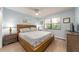 Bright bedroom with beachy decor, wood-look floors, and a large window for natural light at 105 Woodlake Wynde, Oldsmar, FL 34677