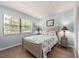 Cozy bedroom with a large window, natural light and wood look floors at 105 Woodlake Wynde, Oldsmar, FL 34677
