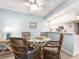 Cozy dining area features wicker chairs, a glass-top table, and easy access to the kitchen at 105 Woodlake Wynde, Oldsmar, FL 34677