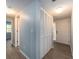 Well-lit hallway with wood-look flooring and ample closet space near the front door at 105 Woodlake Wynde, Oldsmar, FL 34677
