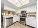 Well-equipped kitchen featuring stainless steel appliances, white cabinets, and ample counter space at 105 Woodlake Wynde, Oldsmar, FL 34677