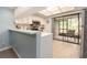 Bright kitchen with stainless appliances and a breakfast bar, next to the outdoor lanai at 105 Woodlake Wynde, Oldsmar, FL 34677