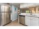 Modern kitchen showcasing stainless steel appliances, white cabinetry, and open layout at 105 Woodlake Wynde, Oldsmar, FL 34677