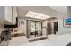 Well-lit kitchen with quartz counters, stainless appliances and easy access to the balcony for outdoor dining at 105 Woodlake Wynde, Oldsmar, FL 34677