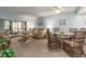 Bright living room featuring a dining area, light blue walls, and sliding doors to the lanai at 105 Woodlake Wynde, Oldsmar, FL 34677