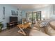Inviting living room with a TV, comfortable seating, and sliding glass doors to the patio at 105 Woodlake Wynde, Oldsmar, FL 34677