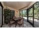 Enclosed patio with dining set, offering a comfortable outdoor dining experience at 105 Woodlake Wynde, Oldsmar, FL 34677